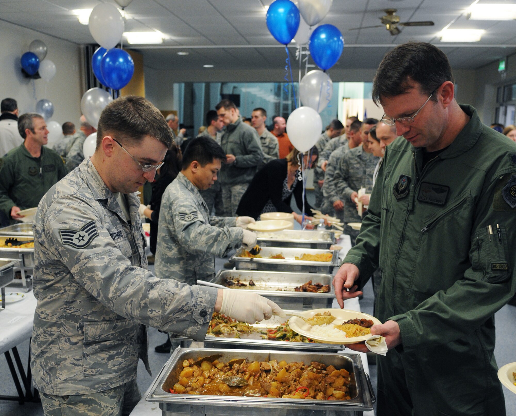 RAF MILDENHALL, England -- Staff Sgt. Lyle Ruthford, 100th Air Refueling Wing Chapel chaplain assistant, serves food to Lt. Col. Kelly Passmore, 67th Special Operations Squadron commander, during the National Prayer Luncheon Feb. 11, 2011, at the base chapel. Airmen from all faiths were invited to the event that reminds them about their right to freedom of religion. (U.S. Air Force photo/Staff Sgt. Thomas Trower)