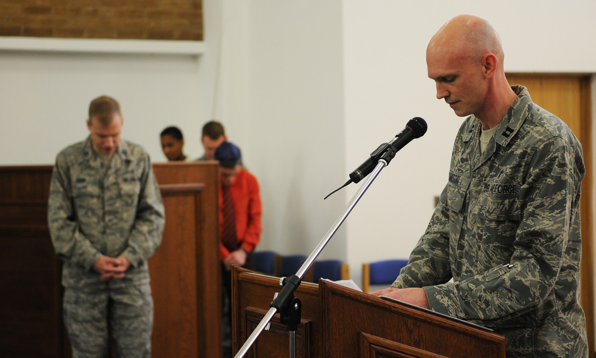 RAF MILDENHALL, England -- Chap. (Capt.) Martin Adamson, 100th Air Refueling Wing Chapel (right), gives the opening prayer for the National Prayer Luncheon Feb. 11, 2011, at the base chapel. This annual event mimics a Washington D.C. tradition that has taken place since 1953. (U.S. Air Force photo/Staff Sgt. Thomas Trower)