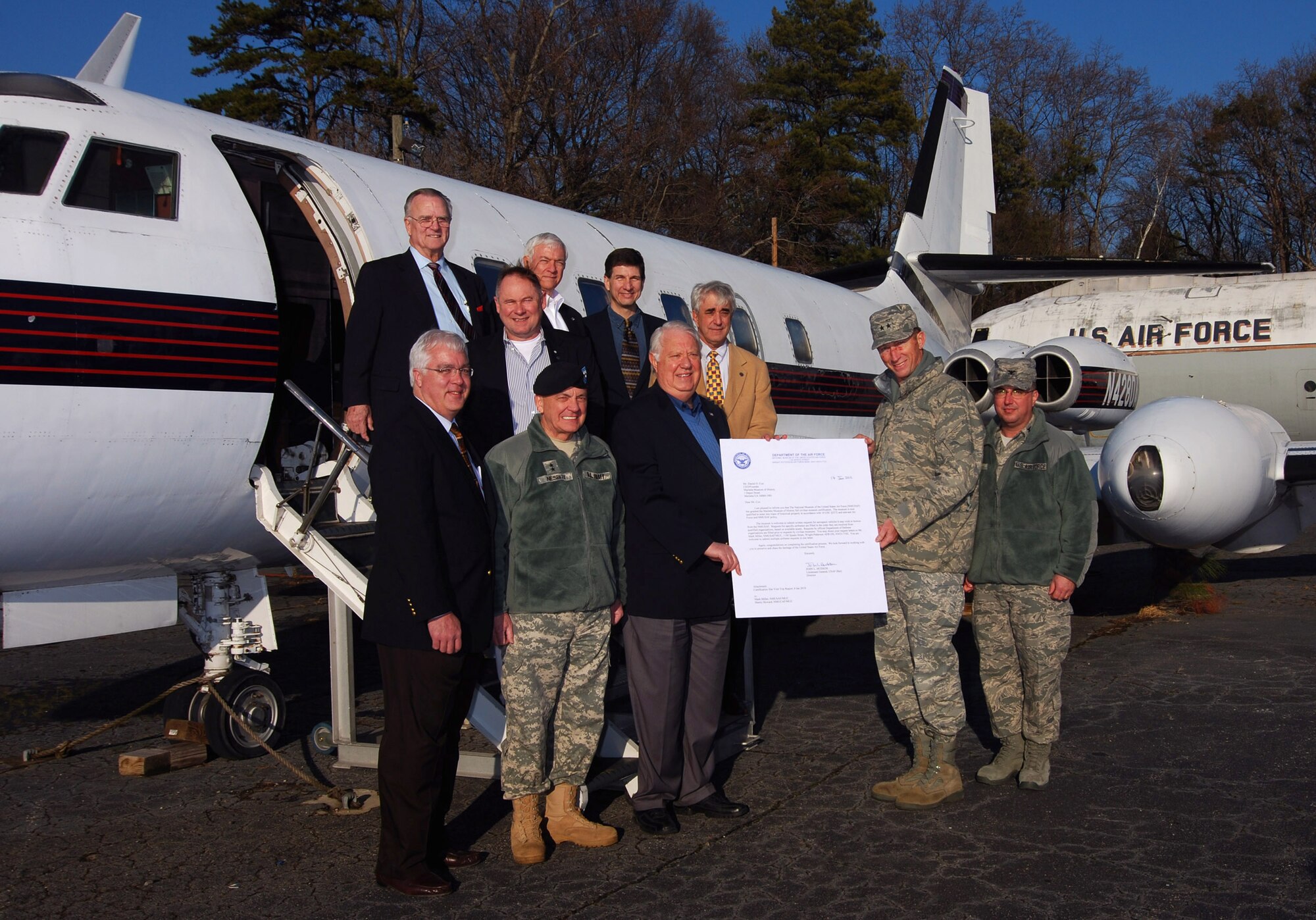 Mr. Tim Lee, Chairman of Cobb County Board of Commissioners, Maj. Gen. William T. Nesbitt, Adjutant General of the Georgia National Guard, Mr. Harlon Crimm, Chairman of the Marietta Museum of History, Maj. Gen. James T. Rubeor, Commander, 22nd Air Force and Col. Patrick W. Webb from the 94th Airlift Wing, Dobbins Air Reserve Base, display the certification letter from the National Museum of the United States Air Force.   They are joined by Mr. Dennis Brown and Mr. Steve Tomlin (middle row), and Mr. Dan Cox, Mr. Alan Price, and Mr. Philip Stein (back row).  The certification allows the museum to receive aircraft on loan from the Air Force for display purposes.  (U.S. Air Force photo/ Brad Fallin)