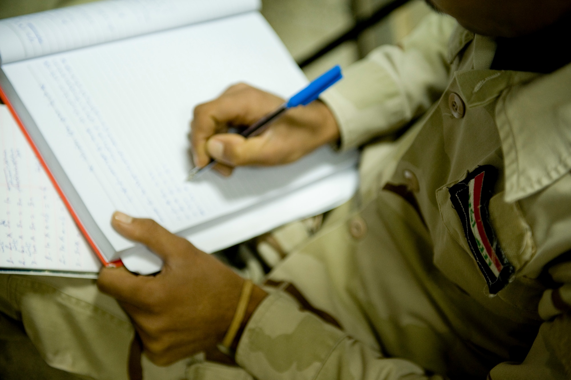 BAGHDAD -- An Iraqi airman takes notes during training on a torque wrench calibration system at New Al-Muthana Air Base, Feb. 2. U.S Airmen taught Iraqi airmen how to calibrate their own torque wrenches, eliminating the need to send the wrenches to the U.S. for this process. (U.S. Air Force photo by Staff Sgt. Levi Riendeau)