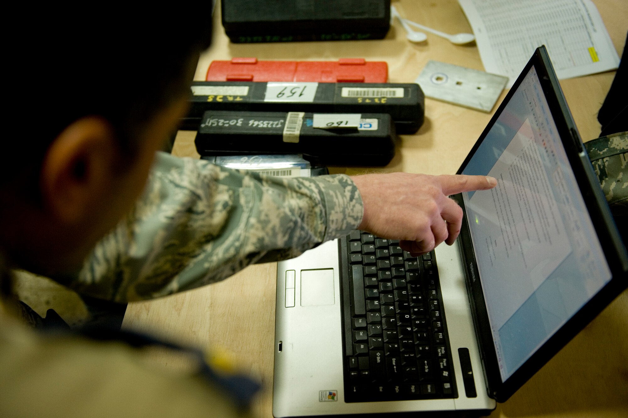 BAGHDAD -- An Iraqi airman learns how to use tool calibration technical orders at New Al-Muthana Air Base, Feb. 2. A  two-man team of U.S. Airmen spent three weeks training Iraqi airmen to calibrate their own torque wrenches, eliminating the need to send the tools to the U.S. for this process. (U.S. Air Force photo by Staff Sgt. Levi Riendeau)