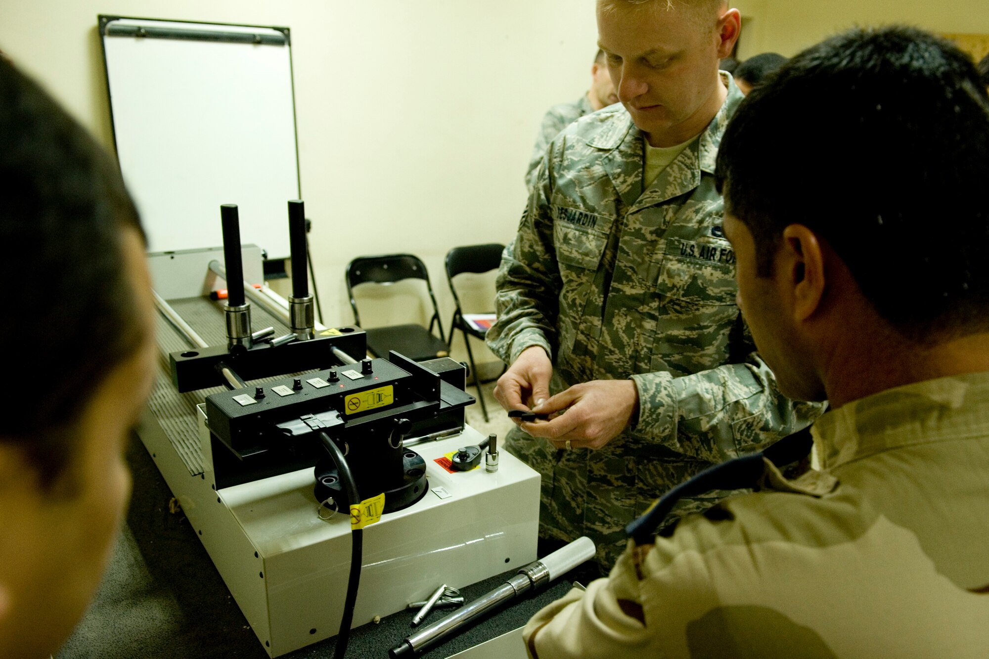 BAGHDAD -- U.S. Air Force Master Sgt. Joel Desjardin trains Iraqi airmen on the proper calibration of torque wrenches at New Al-Muthana Air Base, Feb. 2. Sergeant Desjardin is part of a two-man team sent to train the Iraqi airmen, saving them time and money. Sergeant Desjardin is a native of Rochester, N.Y., and is deployed from Seymour Johnson Air Force Base, N.C. (U.S. Air Force photo by Staff Sgt. Levi Riendeau)