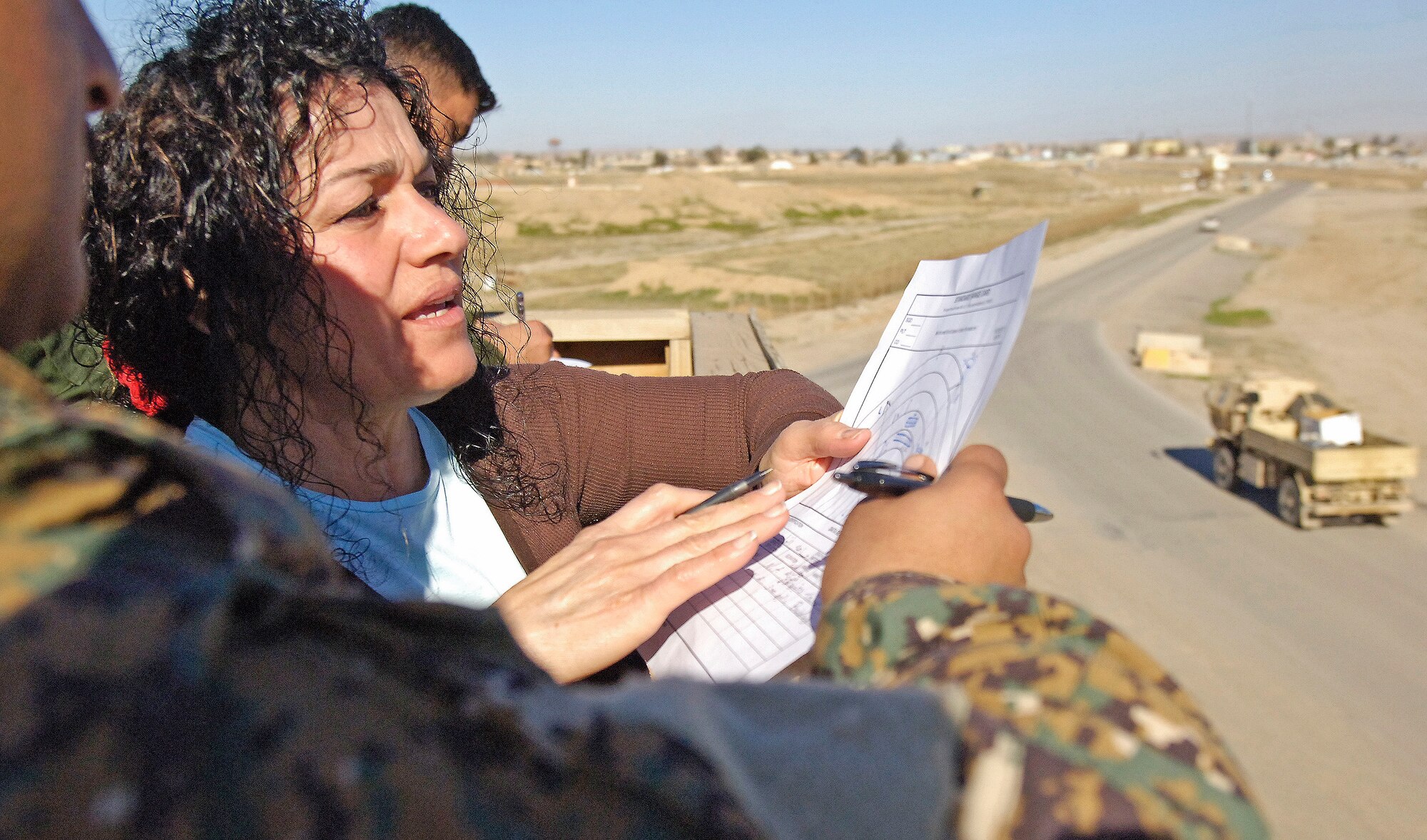"Zeena," a translator at Kirkuk Regional Air Base, helps Iraqi airmen fill out a standard range card during a week-long security forces training course with U.S. Army military policemen. The 321st Expeditionary Mission Support Advisory Group’s base transition team orchestrated the event to prepare the Iraqi air force airmen as they take on increasing responsibility over the base. (U.S. Air Force/Tech. Sgt. Jason Lake)