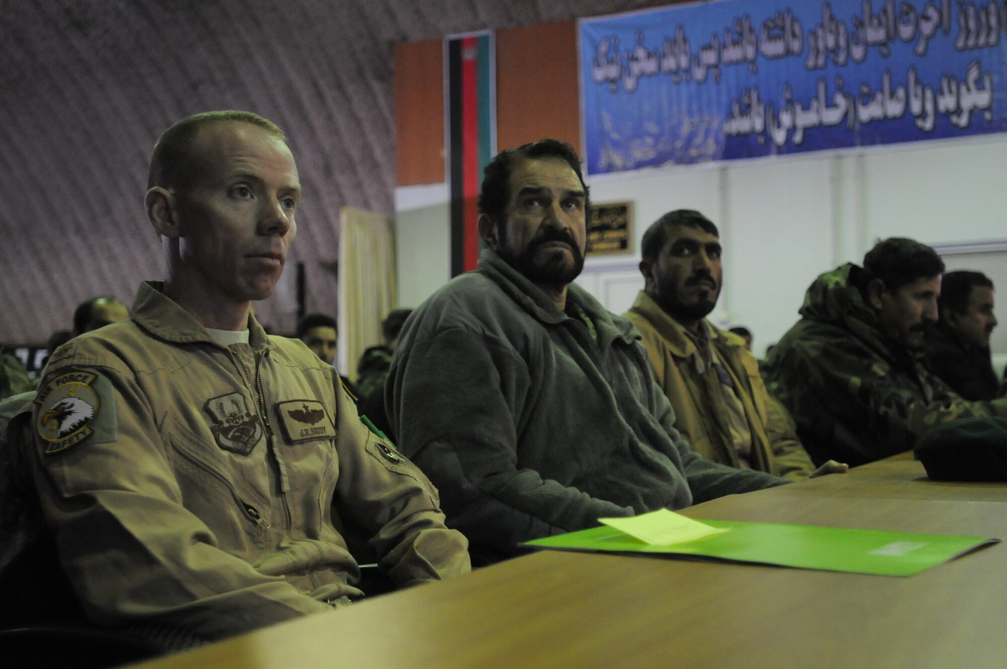 KABUL, Afghanistan -- Afghan Air Force Airmen and NATO Air Training Command-Afghanistan advisors listen to a speech during the AAF “Afghanistan Safety Day” at the Afghan Air Force Base in Kabul Feb. 13. (U.S. Navy photo by Mass Communications Specialist 2nd Class Vladimir Potapenko)