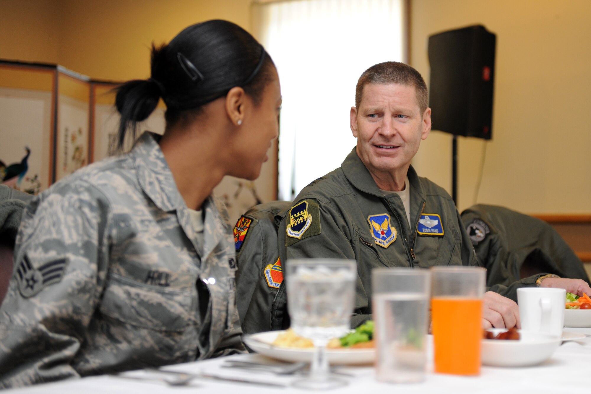 KUNSAN AIR BASE, Republic of Korea -- Maj. Gen. Robin Rand, Special Assistant to the Vice Chief of Staff, Headquarters U.S. Air Force, chats with Senior Airman Jasmine Hill, 35th Fighter Squadron member, during a lunch with Wolf Pack Airmen while on a base visit here Feb. 11.  In addition to dining with Airmen, General Rand also  visited Big Coyote and various other facilities throughout the base. (U.S. Air Force photo/Tech. Sgt. Jonathan Pomeroy) 