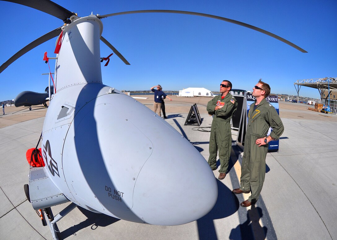 U.S. Navy pilots stand near a Fire Scout unmanned aerial  vehicle that was part of a display of current and retired Navy aircraft on Naval Air Station North Island, in San Diego, Feb. 11, 2011.