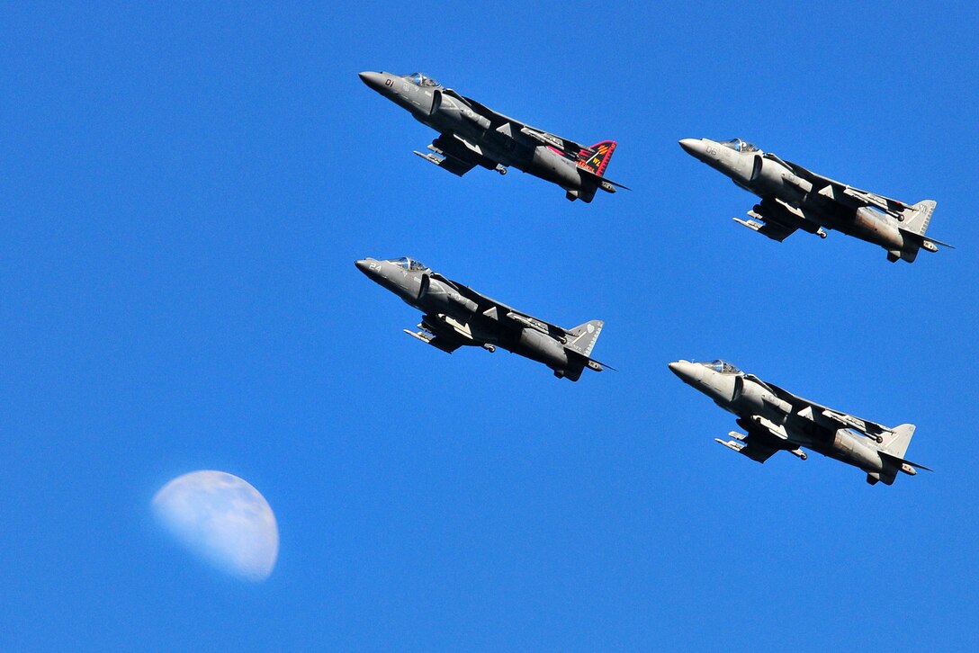 Four AV-8B Harriers appear near the moon as they fly over San Diego Bay near Naval Air Station North Island, Feb. 12, 2011.