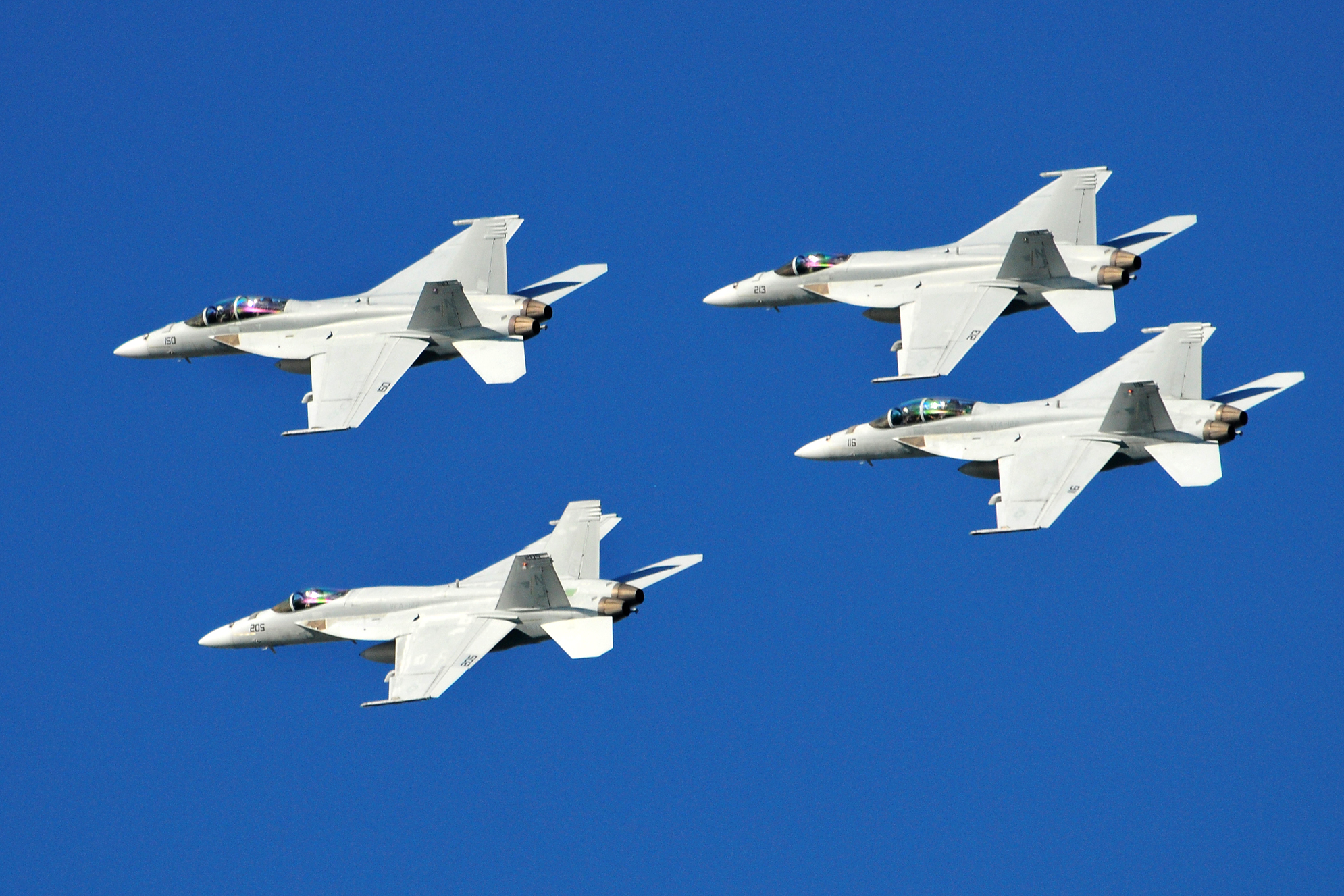 A formation of F/A18 strike fighters fly over San Diego Bay