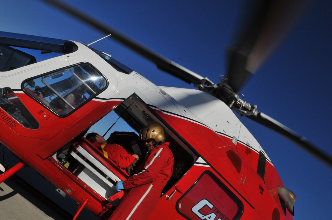 A medical responder with the Yuma Regional Medical Center prepares Lance Cpl. Michelle Rhea, Installation Personnel and Administrative Center separations clerk, to be evacuated by helicopter to the center during Exercise Desert Impact on the  flight line at Marine Corps Air Station in Yuma, Ariz., Feb. 14, 2011. More than 400 Marine, sailors and civilians participated in the event, which called for station collaboration with civilian and federal agencies to diffuse a simulated scenario in which a terrorist shot down an aircraft during the station’s annual air show.