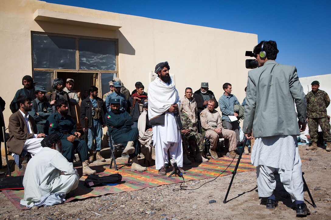 Garmsir District Governor Mohammad Fahim addresses approximately 300 locals who attended the ribbon cutting of the Laki Girls School, in Garmsir district, Helmand province, Afghanistan, Feb. 15.