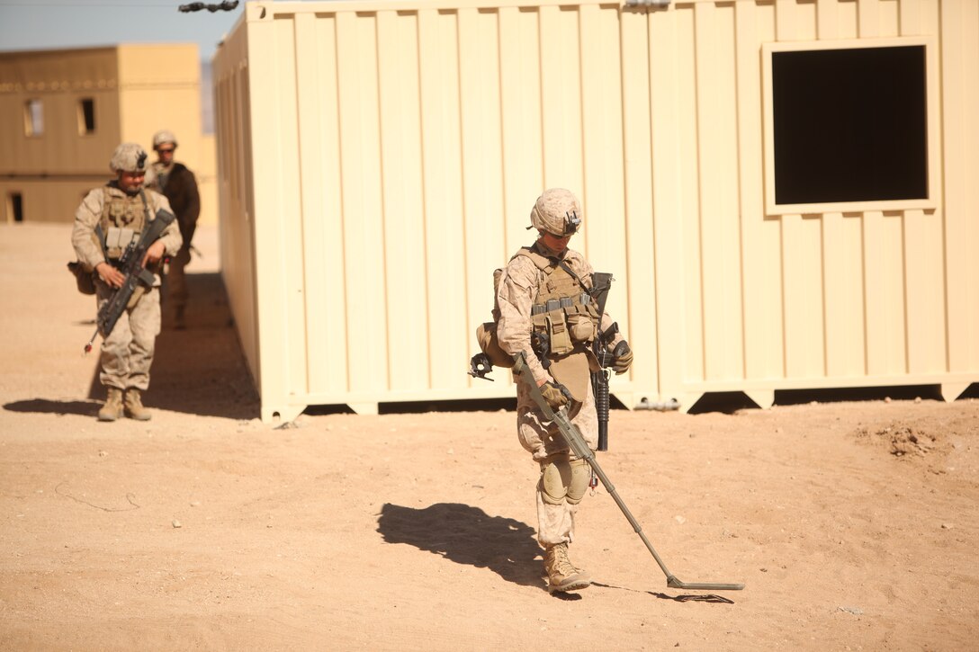 Marines with  1st Battalion, 5th Marine Regiment patrol the streets of the Combat Center’s new combined arms, live-fire, Military Operations on Urban Terrain training range, in search of improvised explosive devices  as part of Enhanced Mojave Viper, Feb. 15, 2011.