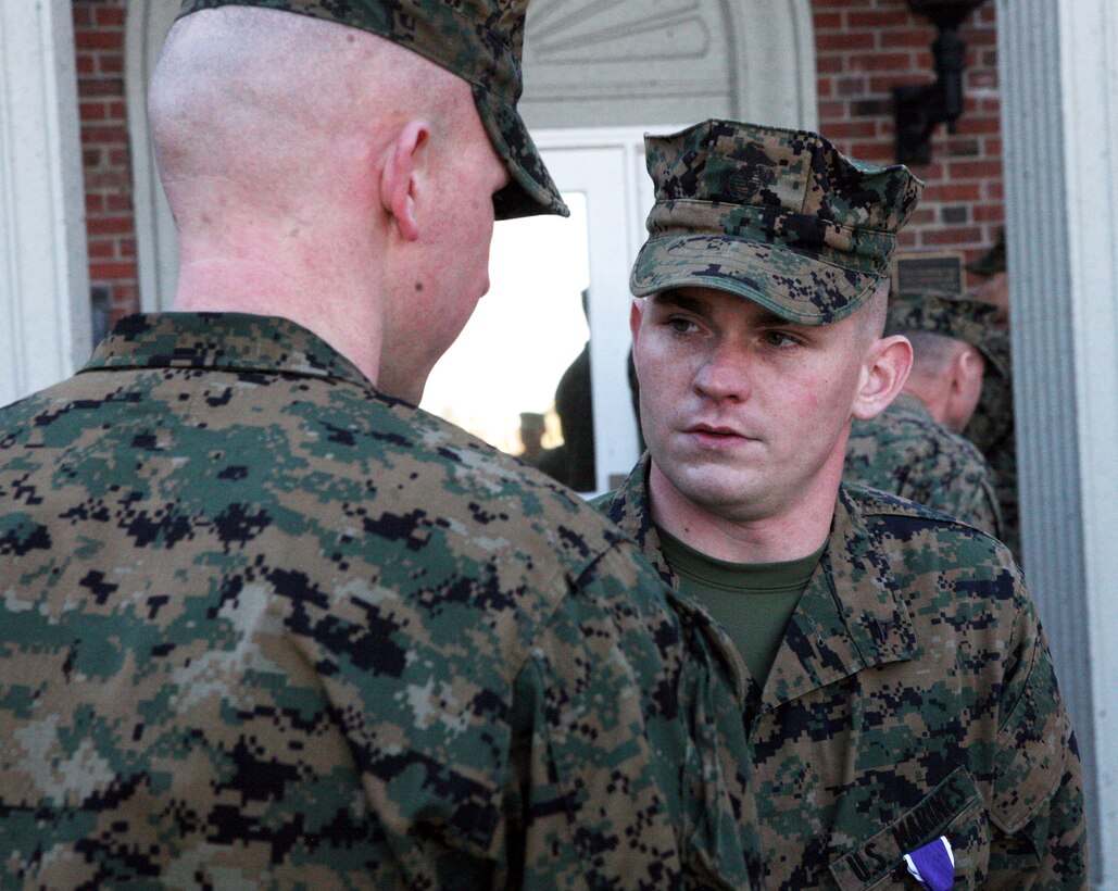 Lance Cpl. Brian K. Steele, a combat engineer with 2nd Marine Logistics Group, gets congratulated during a purple heart ceremony in front of the 2nd MLG Headquarters building aboard Camp Lejeune, N.C., Feb. 14, 2011. Steele was a vehicle commander during a convoy near Forward Operating Base Hansen when his vehicle struck an improvised explosive device. (U.S. Marine Corps photo by Pfc. Franklin E. Mercado)