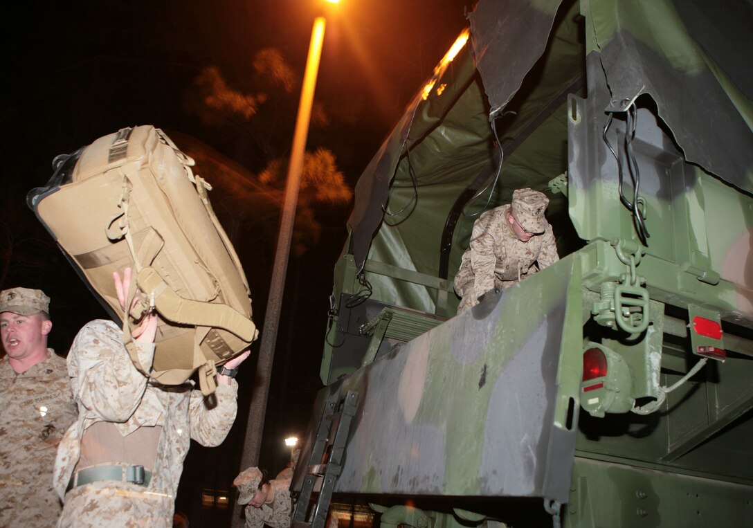 Marines with 2nd Marine Logistics Group (Forward) load their deployment bags onto a Marine Corps "7-ton" Medium Tactical Vehicle Replacement at the French Creek Reception Center aboard Camp Lejeune, N.C., Feb. 15. The unit is slated for a year-long deployment to Afghanistan's Helmand province in support of International Security Assistance Force operations. (U.S. Marine Corps photo by Sgt. Justin J. Shemanski)