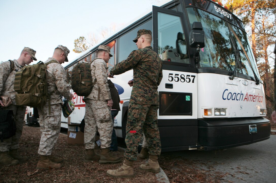 Marines with 2nd Marine Logistics Group (Forward) take the first steps of their deployment by boarding chartered buses at the French Creek Reception Center aboard Camp Lejeune, N.C., Feb. 15. Members of 2nd MLG (FWD) will embark on a year-long deployment to Afghanistan's Helmand province in support of International Security Assistance Force operations. (U.S. Marine Corps photo by Sgt. Justin J. Shemanski)