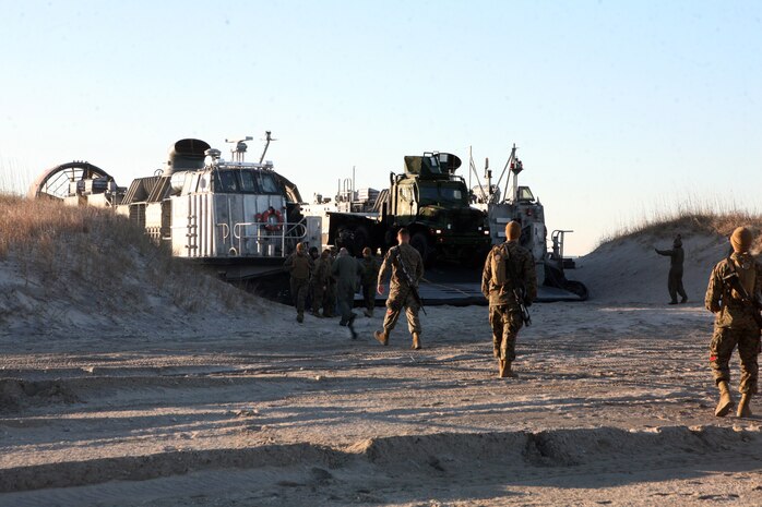 Marines with Combat Logistics Regiment 25, 2nd Marine Logistics Group, move equipment off a Landing Craft Air Cushion during an amphibious training exercise at Onslow Beach aboard Camp Lejeune, N.C., Feb. 15, 2011. The purpose of the exercise was to ensure the readiness of the unit’s amphibious operations, along with highlighting the navy and Marine Corps team and what it can be capable of when working together as on unit. (U.S. Marine Corps photo by Pfc. Franklin E. Mercado)