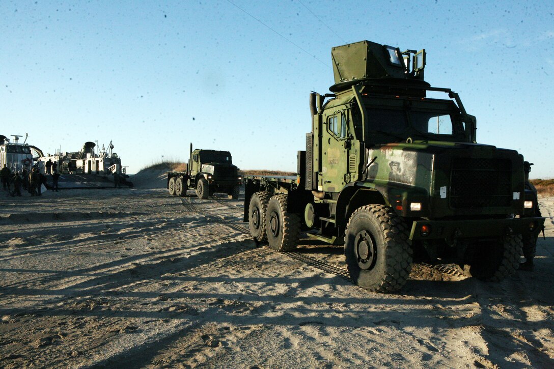 Marines with Combat Logistics Regiment 25, 2nd Marine Logistics Group, move seven tons off a Landing Craft Air Cushion during an amphibious training exercise at Onslow Beach aboard Camp Lejeune, N.C., Feb. 15, 2011. The purpose of the exercise was to ensure the readiness of the unit’s amphibious operations, along with highlighting the navy and Marine Corps team and what it can be capable of when working together as on unit. (U.S. Marine Corps photo by Pfc. Franklin E. Mercado)