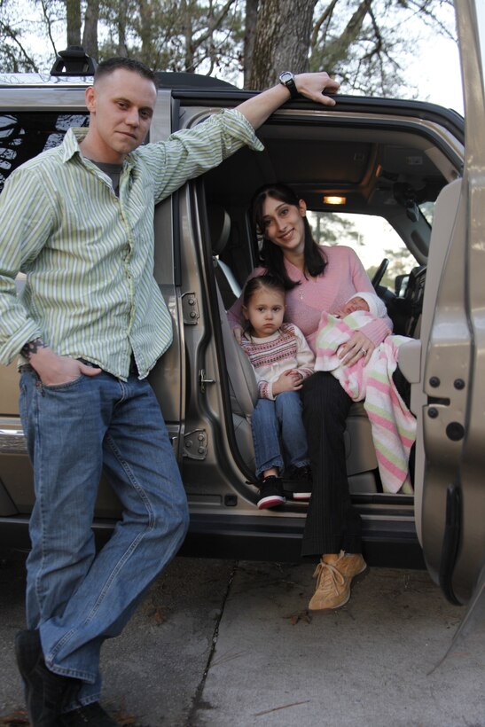 Staff Sgt. Johnathon M. Waytas, aviation ordnance instructor with the Center for Naval Aviation Technical Training Marine Unit Cherry Point, and his family pose in their Jeep Commander at his home Feb. 15. Seven days earlier, Waytas delivered his newborn daughter, Krisily, in the Jeep. “I’m really proud of my wife and admire the way she dealt with whole process,” said Waytas.