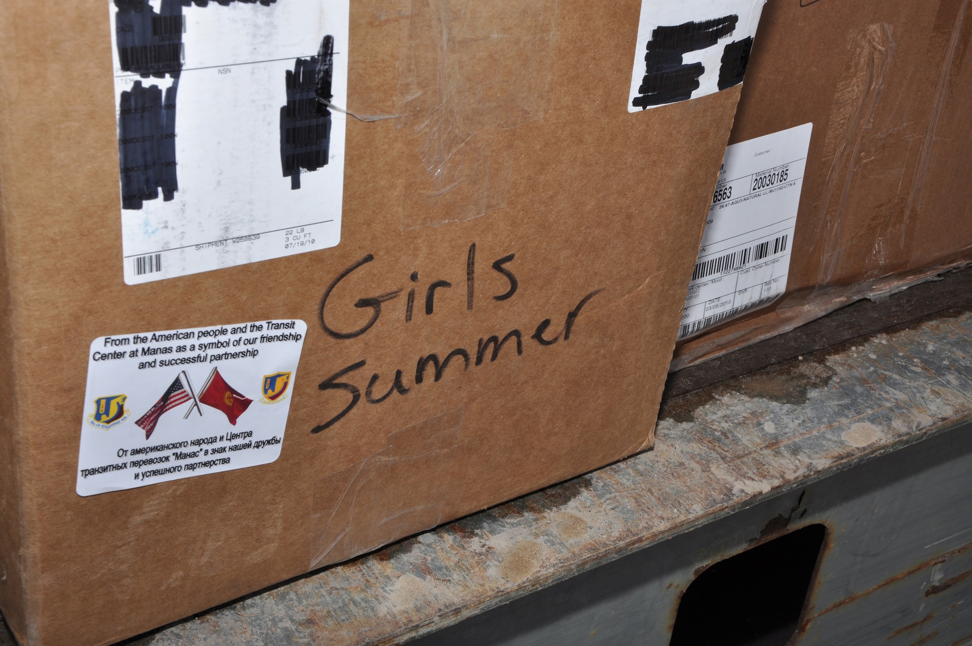 TRANSIT CENTER AT MANAS, Kyrgyzstan – One of many boxes containing donated goods consisting of clothes, toys, linens and other miscellaneous household items awaiting transfer from the Transit Center to nongovernmental orgranizations Feb. 15. The goods came from RAF Mildenhall, United Kingdom, Yokota Air Base, Japan, and various parts of the United States. NGOs such as Central Asian Partnership, Crosslink Development International and the American Charitable Fund of Scientific Technology and Language Institute in Kyrgyzstan collected the goods for their causes. This latest round distributed 4,000 lbs of the humanitarian aid to areas including Bishkek and Karakol. (U.S. Air Force photo/Master Sgt. Daniel Nathaniel III)