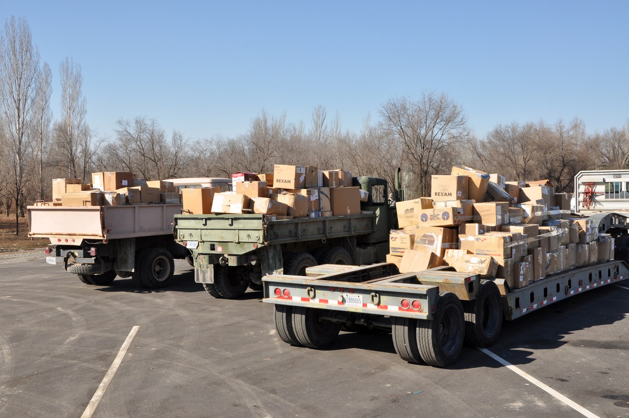 TRANSIT CENTER AT MANAS, Kyrgyzstan – Donated goods consisting of clothes, toys, linens and other miscellaneous household goods await on trucks outside the Transit Center for  transfer to nongovernmental orgranizations Feb. 15. The goods came from RAF Mildenhall, United Kingdom, Yokota Air Base, Japan, and various parts of the United States. NGOs such as Central Asian Partnership, Crosslink Development International and the American Charitable Fund of Scientific Technology and Language Institute in Kyrgyzstan collected the goods for their causes. This latest round distributed 4,000 lbs of the humanitarian aid to areas including Bishkek and Karakol. (U.S. Air Force photo/Master Sgt. Daniel Nathaniel III)