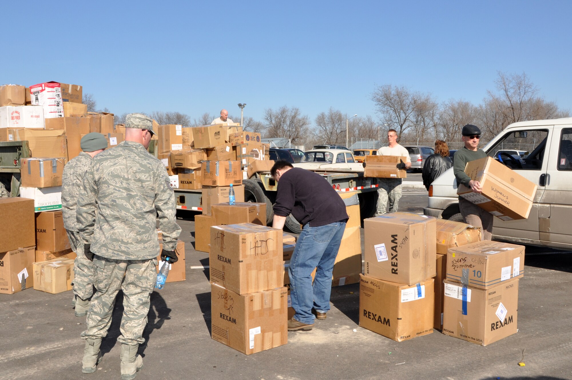 TRANSIT CENTER AT MANAS, Kyrgyzstan – Humanitarian Assistance civil engineers from the Transit Center help Nongovernmental Organization workers load supplies to waiting transports as part of the ongoing humanitarian assistance project Operation Warm & Dry II Feb. 15. The donated goods consisting clothes, toys, linens and other miscellaneous household goods came from RAF Mildenhall, United Kingdom, Yokota Air Base, Japan, and various parts of the United States. NGOs such as Central Asian Partnership, Crosslink Development International and the American Charitable Fund of Scientific Technology and Language Institute in Kyrgyzstan collected the goods for their causes. This latest round distributed 4,000 lbs of the humanitarian aid to areas including Bishkek and Karakol. (U.S. Air Force photo/Master Sgt. Daniel Nathaniel III)