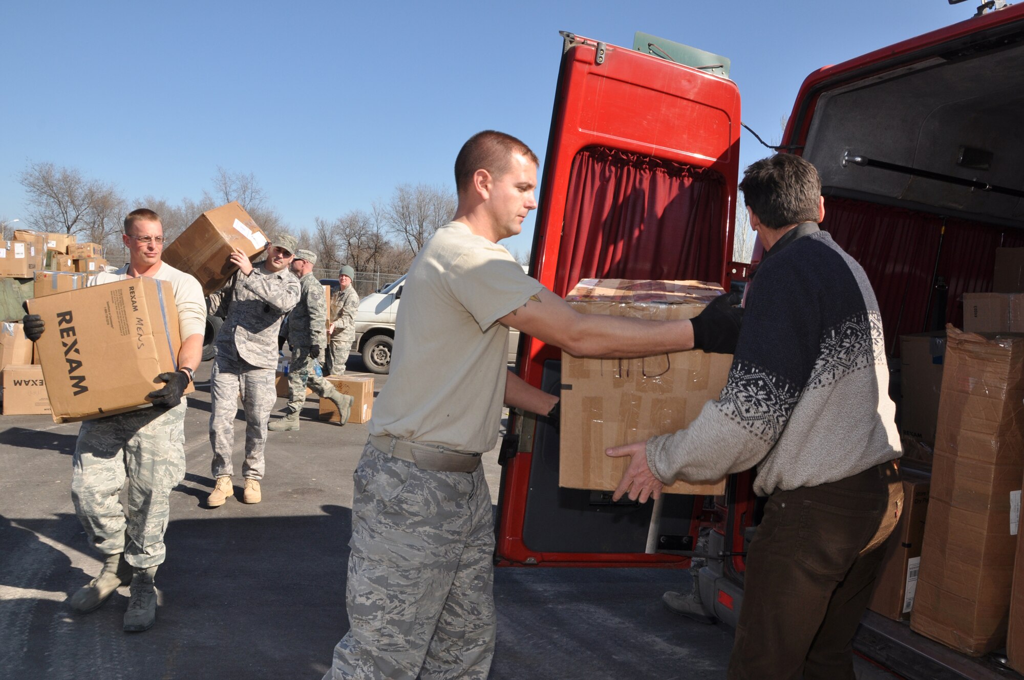 Humanitarian Assistance civil engineers from the Transit Center load donated goods into a van from Crosslink Development International as part of the ongoing humanitarian assistance project Operation Warm & Dry II Feb. 15. Donated goods consisting clothes, toys, linens and other miscellaneous household goods came from RAF Mildenhall, United Kingdom, Yokota Air Base, Japan, and various parts of the United States. Other NGOs such as Central Asian Partnership and the American Charitable Fund of Scientific Technology and Language Institute in Kyrgyzstan collected the goods for their causes as well. This latest round distributed 4,000 lbs of the humanitarian aid to areas including Bishkek and Karakol. (U.S. Air Force photo/Master Sgt. Daniel Nathaniel III)
