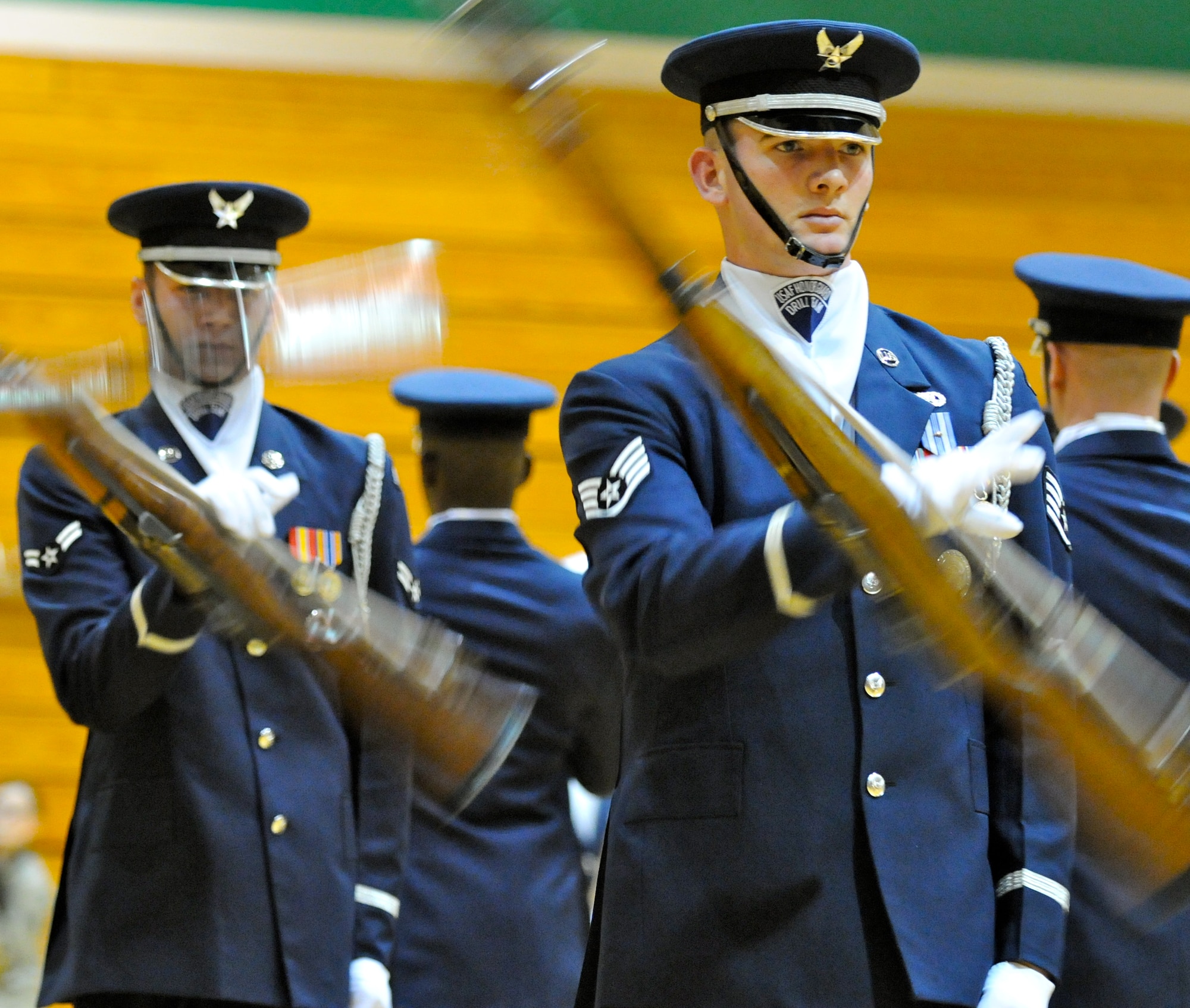 Staff Sgt. Kelly Webster, member of The U.S. Air Force Honor Guard drill team, performs double spins during a performance at his alma mater, Derby High School in Derby, Kan., Feb. 14. Sergeant Webster graduated from Derby HS in 2004. (U.S. Air Force photo by Airman 1st Class Tabitha N. Haynes)