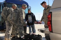 MINOT AIR FORCE BASE, N.D. -- A team of 91st Missile Security Forces Squadron members load travel cargo in a vehicle at Minot International Airport Feb. 9.  The small team of 91st MSFS members returned from a six month deployment to Sather Air Base, Iraq. Their team of 12 were the only 91st MSFS members to deploy in 2010, given the importance of the nuclear mission here. (U.S. Air Force photo/Airman 1st Class Jose L. Hernandez)