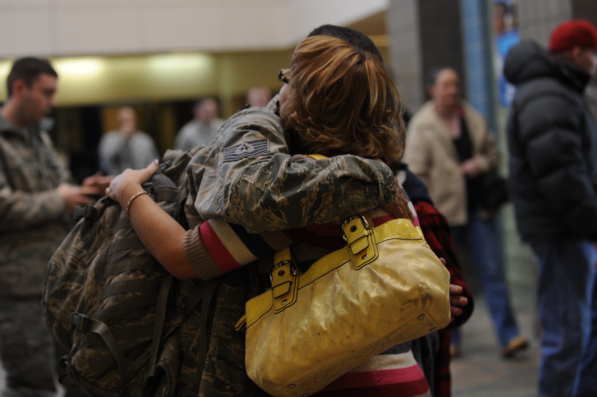 MINOT AIR FORCE BASE, N.D. -- Tech. Sgt. Ray Marquez, 91st Missile Security Forces Squadron flight security controller, embraces his spouse Amy Marquez at the Minot International Airport, after returning from a six month deployment to Sather Air Base, Iraq Feb. 9. Sergeant Marquez was part of a team of 12 91st MSFS members who were the only ones to deploy in 2010, given the importance of the nuclear mission here. (U.S. Air Force photo/Airman 1st Class Jose L. Hernandez)

