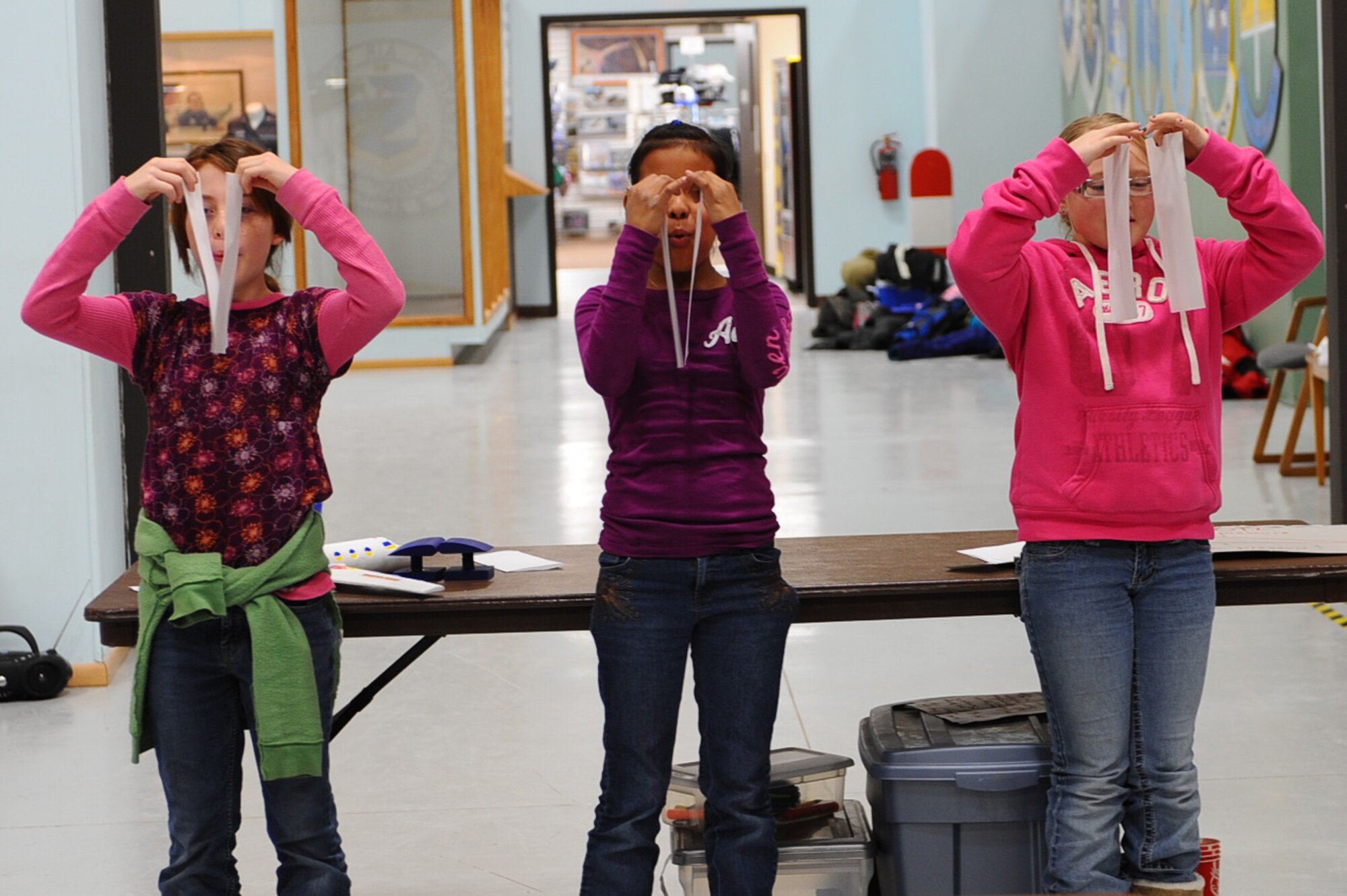 (From left to right) Ajiah Pierce, Raya Garrett, and Bobbi Antonsen, fifth graders, blow through two pieces of paper to demonstrate Bernoulli’s Principle during their STARBASE visit at the South Dakota Air and Space Museum, Feb. 11, 2011. Bernoulli’s Principle describes how increased velocity leads to decreased pressure and lift. (U.S. Air Force photo/Senior Airman Kasey Close)