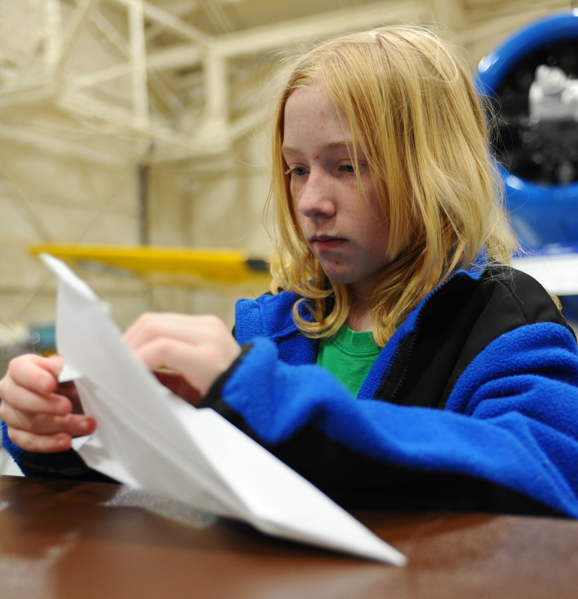 Rosemary Hoon, a fifth grader, creates a paper airplane during an activity with the STARBASE visit at the South Dakota Air and Space Museum, Feb. 11, 2011. STARBASE is a Department of Defense program providing students with 20-25 hours of instruction and stimulating experiences at National Guard, Navy, Marine, Air Force Reserve and Air Force installations across the nation. (U.S. Air Force photo/Senior Airman Kasey Close)