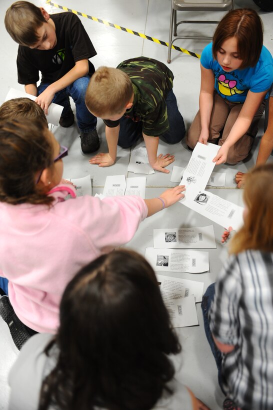 Fifth graders piece together a timeline during their STARBASE visit at the South Dakota Air and Space Museum, Feb. 11, 2011. STARBASE is a Department of Defense program designed to raise interest and improve knowledge and skills of at-risk youth in science, technology, engineering and mathematics. (U.S. Air Force photo/Senior Airman Kasey Close)
