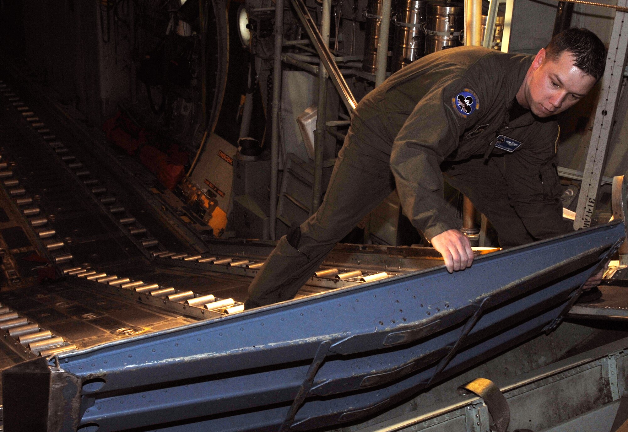 Staff Sgt. Dave Sanders, a 62nd Airlift Squadron loadmaster, secures the loading ramp on a C-130, at Little Rock Air Force Base, Ark., Feb. 14, 2011. Part of Sergeant Sanders checks includes ensuring the ramps are secure before takeoff. (U.S. Air Force photo by Airman 1st Class Rusty Frank)