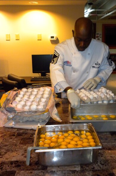 Senior Master Sgt. Tyrone Williams, Air Force Mortuary Affairs Operations Port Mortuary superintendent, prepares the eggs for a breakfast the Top 3 hosted here Feb. 14, 2011. (U.S. Air Force photo/Capt. Trey Johnson)         