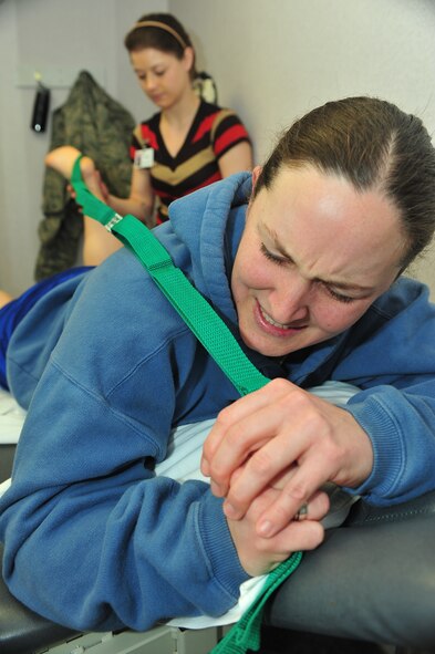 MINOT AIR FORCE BASE, N.D. – Katie Peterson, a physical therapist with Trinity Outpatient Therapy and Sports Medicine, performs range of motion exercises on Staff Sgt. Ann King, 91st Missile Security Forces Squadron flight security controller, at the Trinity Outpatient Therapy office in downtown Minot Jan. 24. Trinity’s physical therapists perform many procedures to help rehabilitate Team Minot Airmen. (U.S. Air Force photo/Senior Airman Jesse Lopez) 