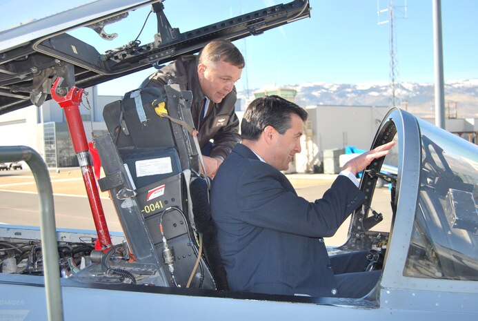 RENO -- Col. Terrence Fornof, the new Nevada Air National Guard commander, gives a cockpit overview of an F-15 Eagle to Gov. Brian Sandoval on the Nevada Air Guard Base flightline in Reno Saturday, Feb. 12. (U.S. Air Force photo/1st Lt Jason Yuhasz)