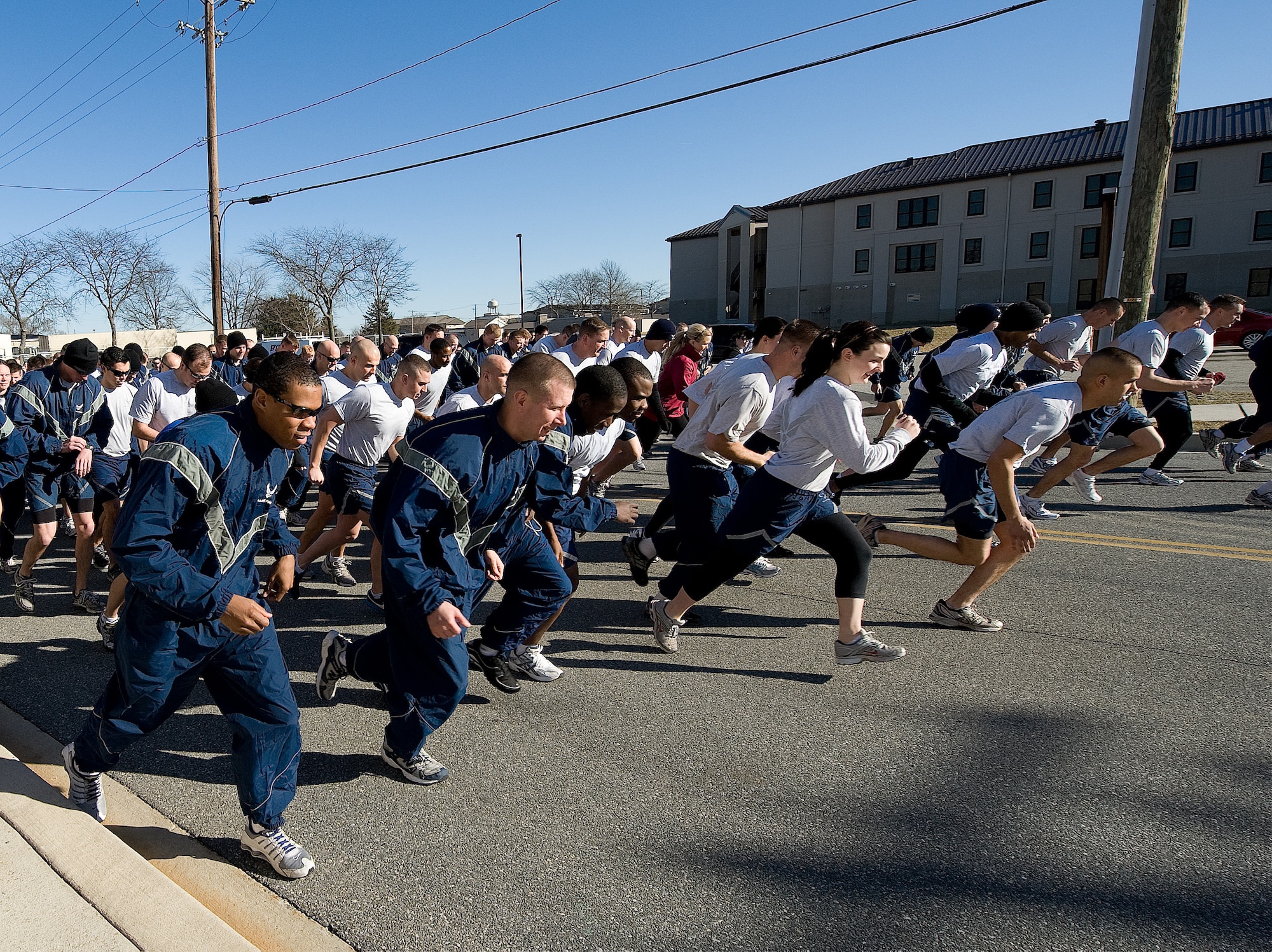 Team Dover members sprint after the starting gun during the Warrior Run at Dover Air Force Base, Del., Feb. 15, 2011.  The Warrior Run is held monthly on base to promote esprit de corps and fitness.  (U.S. Air Force photo by Jason Minto/Released)