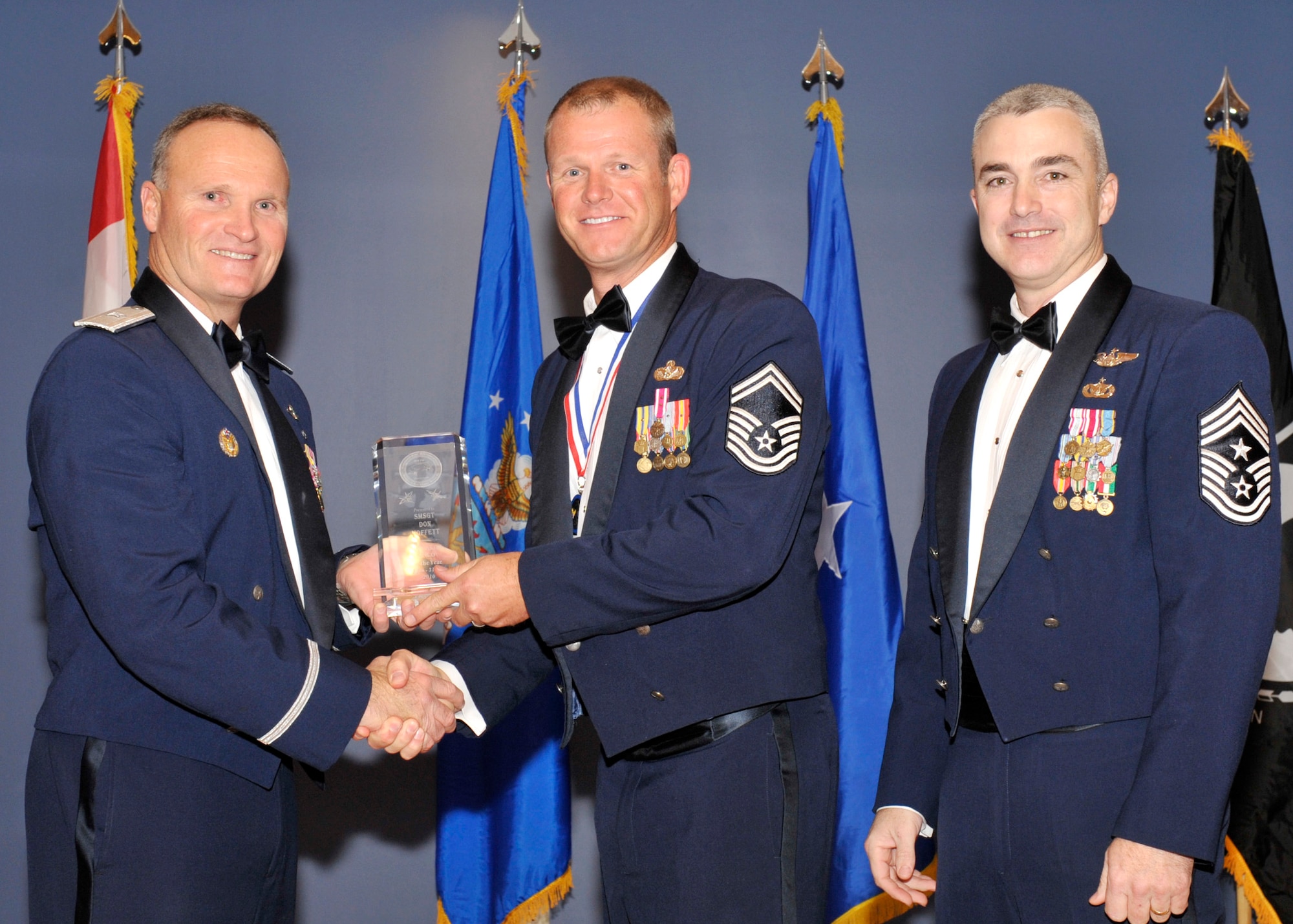 Brigadier Gen. James Browne, 325th Fighter Wing commander, and Chief Master Sgt. Jackie Green, 325th FW command chief, present the award for senior noncommissioned officer of the year to Senior Master Sgt. Dan Moffett, Air Force Civil Engineer Support Agency, during the Tyndall Annual Awards night. (U.S. Air Force photo/Jonathan Gibson)