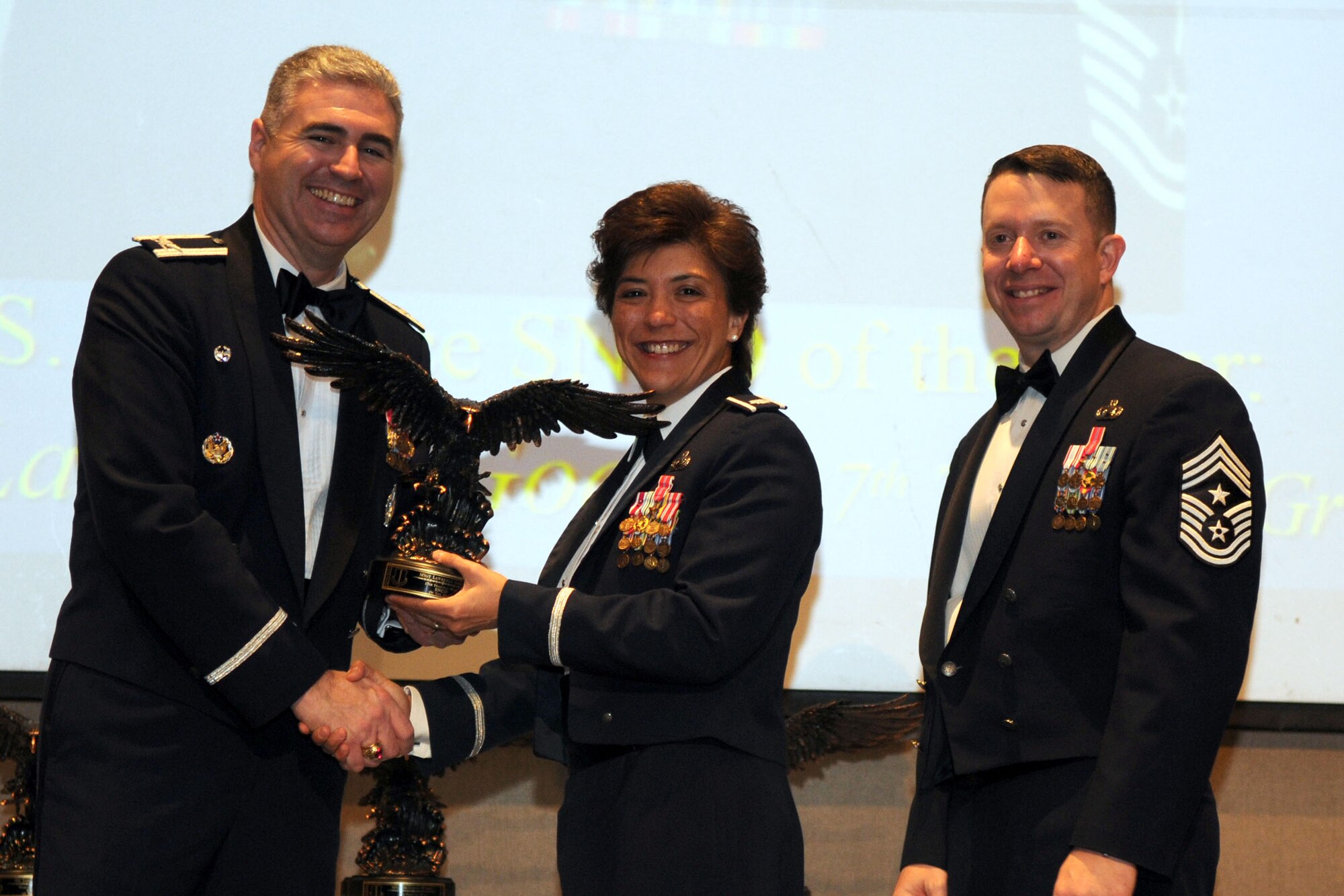 GOODFELLOW AIR FORCE BASE, Texas - Lt. Col. Karen Rolirad, 315th Training Squadron Commander receives the Senior Noncommissioned Officer Annual Award on behalf of Master Sgt. Lawrence Godin, 17th Training Group during the ceremony at the McNease Convention Center, San Angelo, Feb. 11, 2011. (U.S. Air Force photo/Staff Sgt. Heather Rodgers)