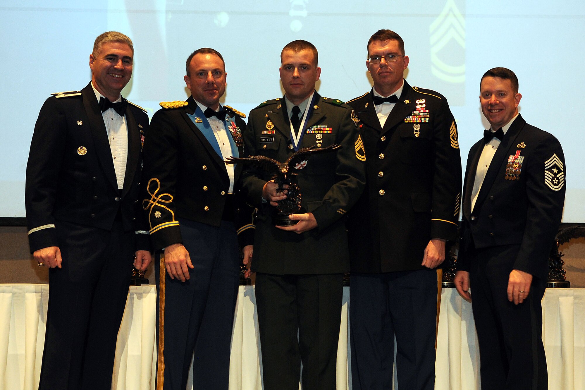 Sgt. 1st Class Jaila Hallett, 344th Military Intelligence Battalion, receives the Noncommissioned Officer of the Year award, during the Annual Awards ceremony at the McNease Convention Center, San Angelo, Texas, Feb. 11, 2011. (U.S. Air Force photo/Staff Sgt. Heather Rodgers)

