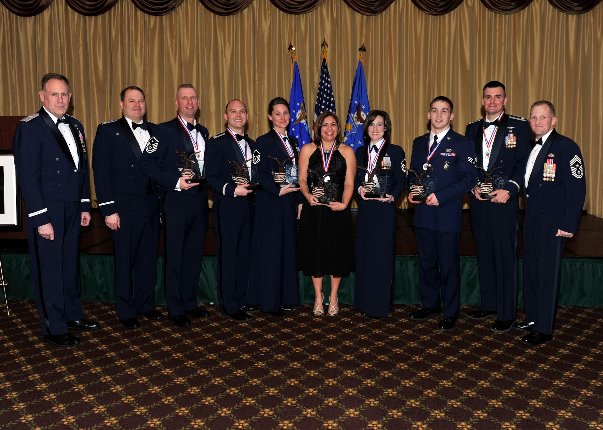 JOINT BASE MCGUIRE-DIX-LAKEHURST, N.J. -- Annual award winners for the 621st Contingency Response Wing gather for a group photo with Brig. Gen. Scott P. Goodwin, 21st Expeditionary Mobility Task Force commander and guest speaker for the evening.  Pictured left to right; Brig. Gen. Scott P. Goodwin, Col. Chris B. Patterson, 621st CRW commander, Master Sgt. Johnny D. Vinson, first sergeant of the year, Maj. J.D. Foy, company grade officer of the year, Master Sgt. Toni A. Wiser, non-commissioned officer of the year, Mrs. Liz Cantre, civilian of the year, Master Sgt. Jennie S. Barlow, senior non-commissioned officer of the year, Senior Airman Paul A. Williams, airman of the year, Maj. Gene A. Jacobus, field grade officer of the year, Chief Master Sgt. Dennis Daubert, command chief for the 621st CRW. (U.S. Air Force photo by Technical Sgt. Laura K. Deckman)(released) 