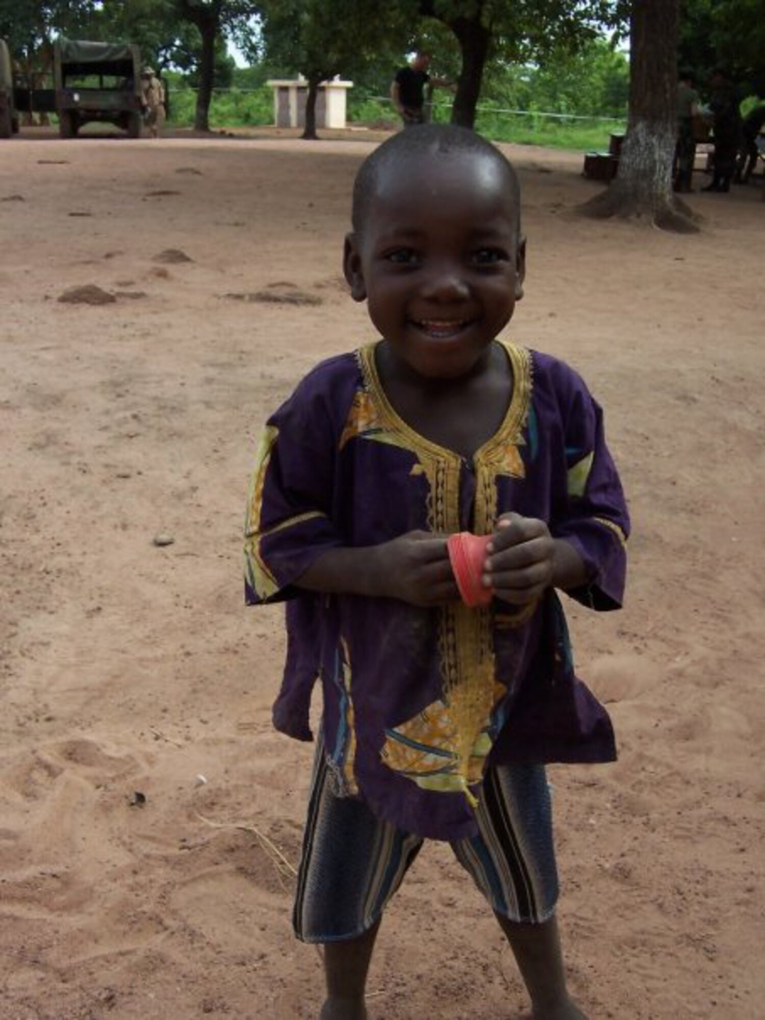 BENIN, Africa - A young boy stops and smiles for the camera while waiting his turn for a vision test. The 920th Resce Wing Aeromedical Staging Squadron performed their two-week annual tour by providing vision tests and glasses to the natives. Despite numerous challenges and language barriers, all found the opportunity greatly rewarding. (U.S. Air Force photo/Tech. Sgt. David Hauser).