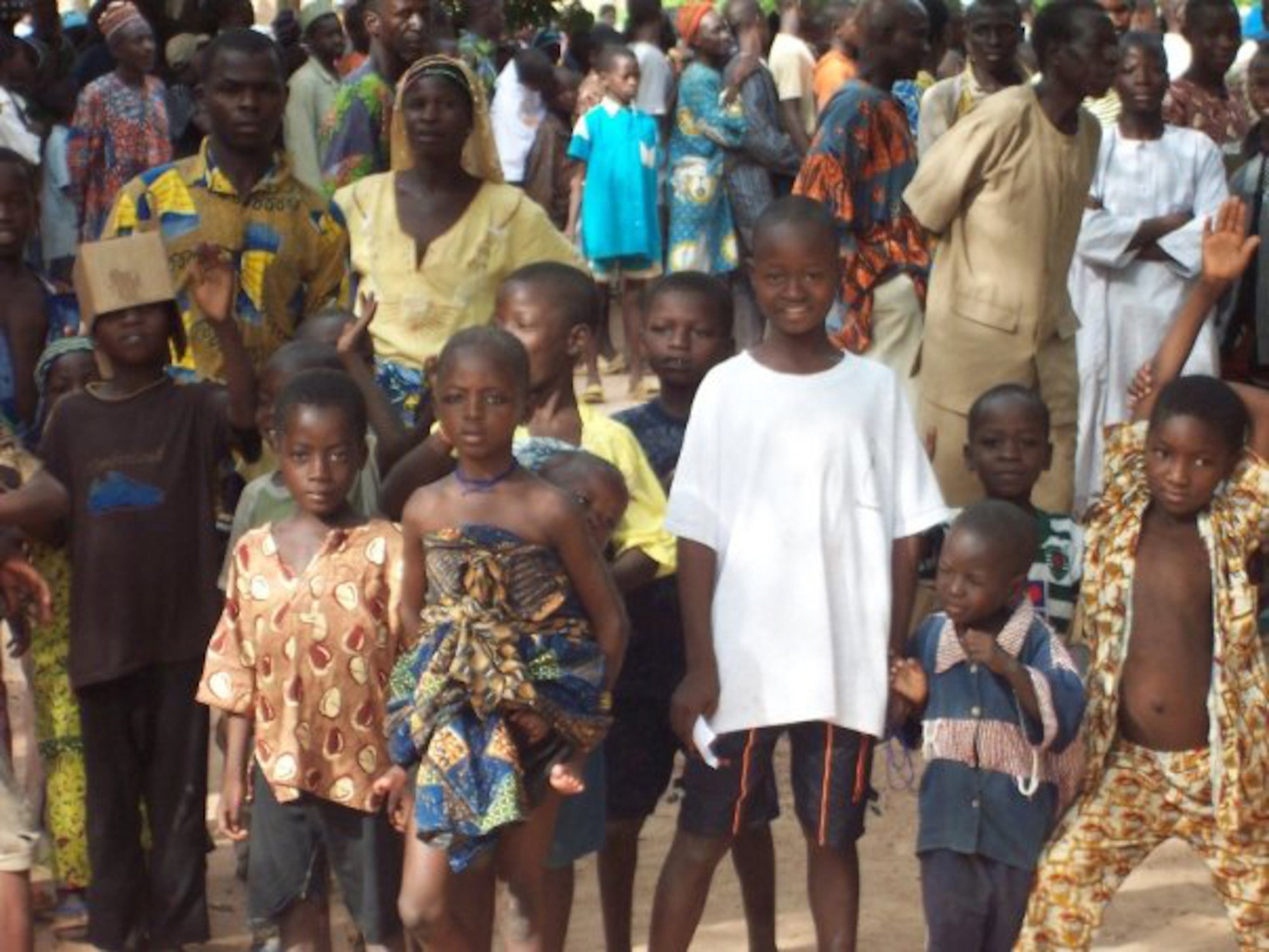 BENIN, Africa - Locals wait in line for vision tests and glasses provided by members of the 920th Rescue Wing Aeromedical Staging Squadron during their two week annual tour. The natives spoke only French and African dialects, forcing Tech. Sgt. David Hauser to use his knowledge of the French language to provide a steady communication flow.  (U.S. Air Force photo/Tech. Sgt. David Hauser).