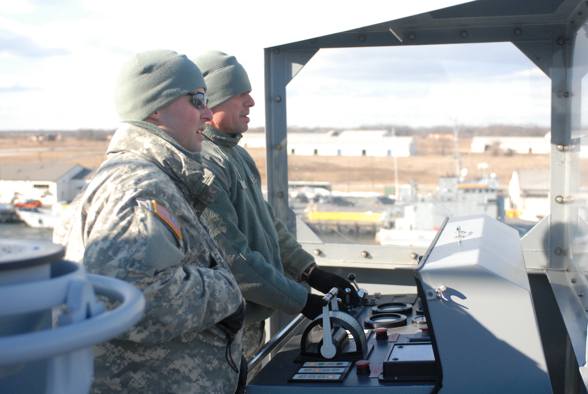 Chief Warrant Officer Steven Brown, 203rd Transportation Company commander and skipper of the LSV-8 MG Robert Smalls, along with Chief Warrant Officer Andrew Kostyn, 2nd mate, steer the ship from its dock in Baltimore harbor. Brown has over 30 years experience with Army watercraft. The Robert Smalls is the sixth ship he’s commanded during his career. Commissioned in 2007, the 314-foot ship can accommodate 12,000 square feet and 2,000 short tons of cargo and boasts a crew of more than 30 Soldiers. (U.S. Army photo/1st Lt. Kevin Skindell)