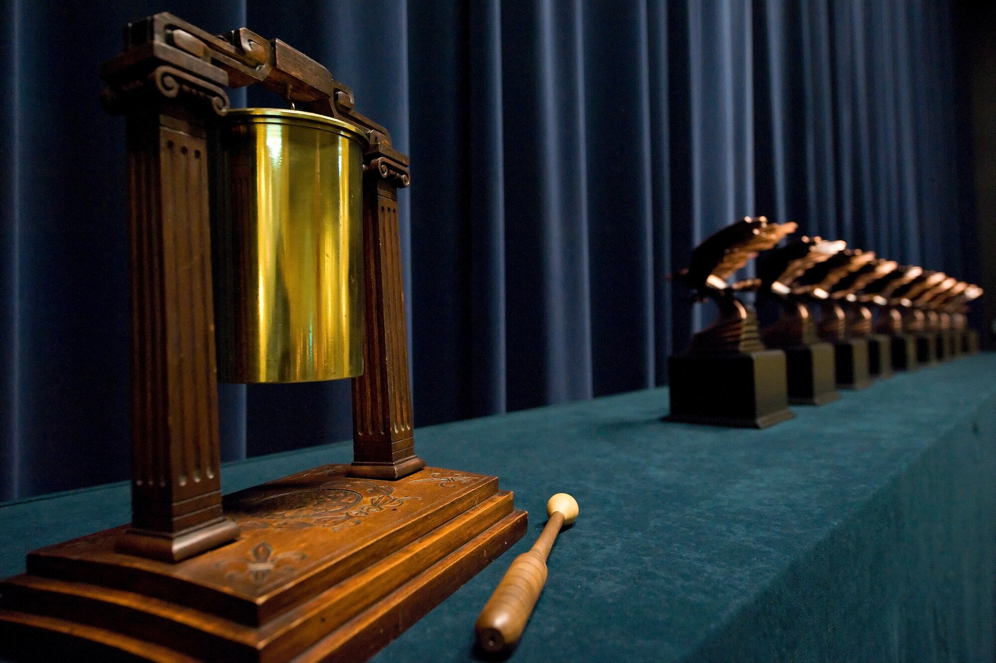 A gong donated by the Air Mobility Command Museum sits next to the 10 awards at the front of the stage. It was used in the ceremony. (U.S. Air Force photo/Roland Balik)