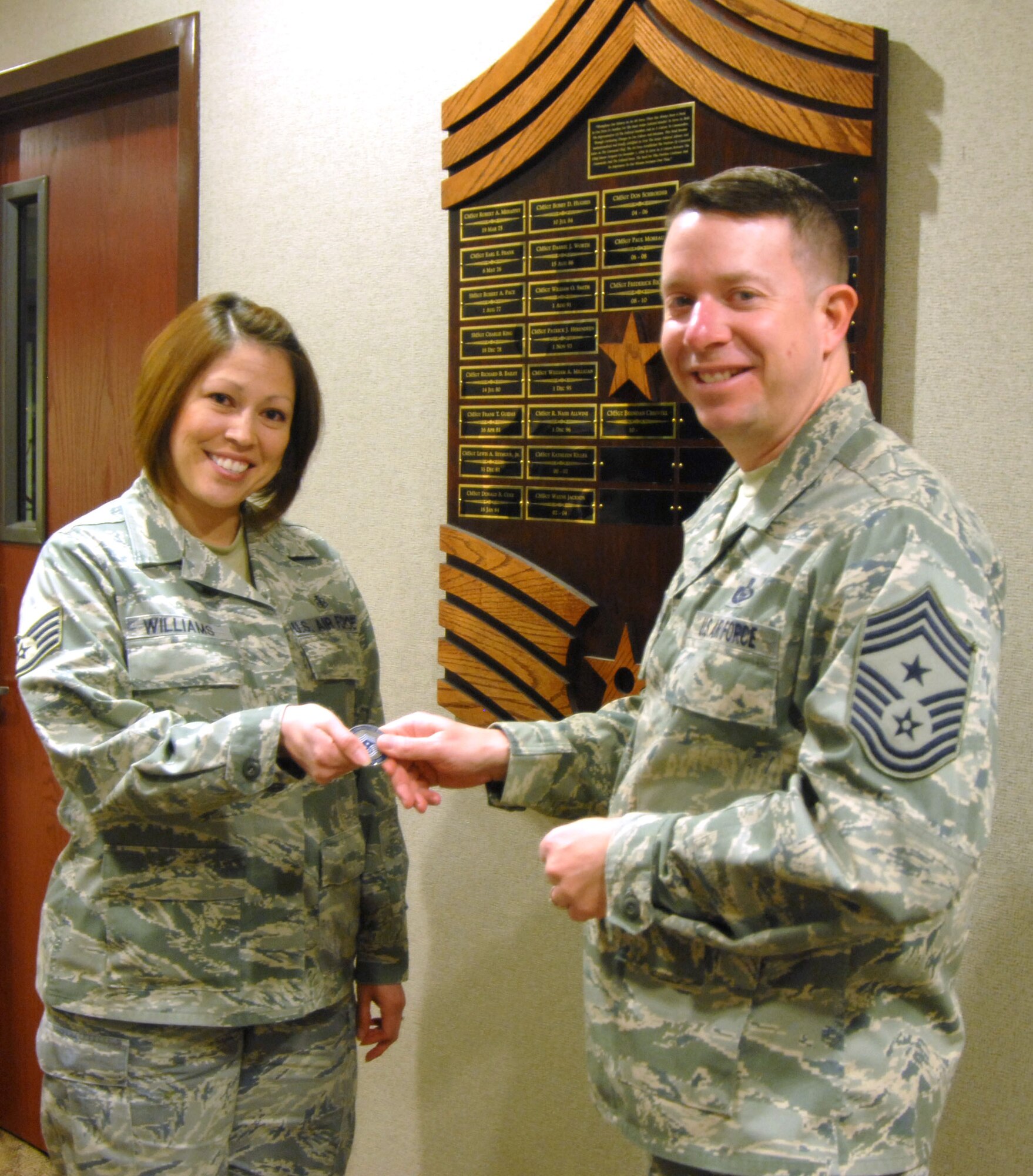GOODFELLOW AIR FORCE BASE, Texas-- Chief Master Sgt. Brendan Criswell, 17th Training Wing Command Chief, presents a 17TRW Command Chief's coin to Staff Sgt. Gisela Williams, 17th Medical Group, after she participated in Chief Criswell's new shadow program, Feb. 8. Seasoned Senior Airmen, Staff Sergeants and recently promoted Technical Sergeants are eligible for the program. (U.S. Air Force photo/Airman 1st Class Jessica D. Keith) 
