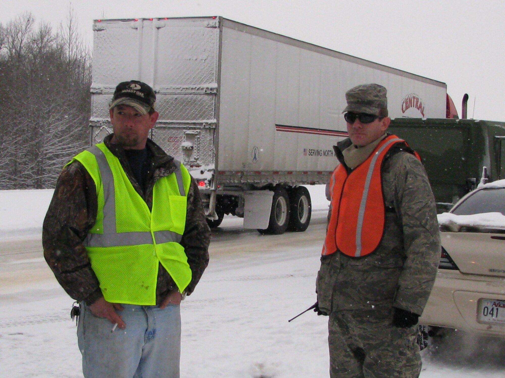 Tech. Sgt. Michael Caffey (right),  a 189th Maintenance Squadron Rapid Augmentation Team member, discusses details of an accident with a civilian truck driver on Highway I-40 Feb. 9, 2011, at Little Rock, Ark. The 189th Airlift Wing team’s primary mission is to provide emergency response and assistance as directed by the governor of Arkansas. (U.S. Air Force photo by Tech. Sgt. James Crawford)