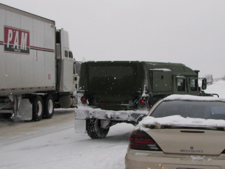 An Arkansas Air National Guard Rapid Augmentation Team vehicle pulls over to provide scene control of an accident on Highway I-40 Feb. 9, 2011, at Little Rock, Ark., until Arkansas Highway Patrol can arrive. The 189th Airlift Wing team’s primary mission is to provide emergency response and assistance as directed by the governor of Arkansas. (U.S. Air Force photo by Tech. Sgt. Michael Caffey)