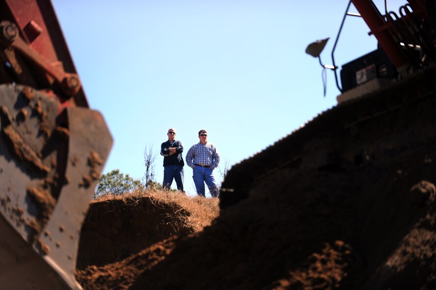 MOODY AIR FORCE BASE, Ga. -- Gary Lamb, 23rd Civil Engineer Squadron heavy equipment shop work leader, and Morgan Spruill, 23rd CES deputy chief of operations, watch other members from the 23rd CES build a berm at the Combat Arms Training and Maintenance range Feb. 14. This berm will be used to keep bullets from traveling past the range and possibly prevent someone from getting injured. (U.S. Air Force photo/Airman 1st Class Douglas Ellis)(RELEASED)
