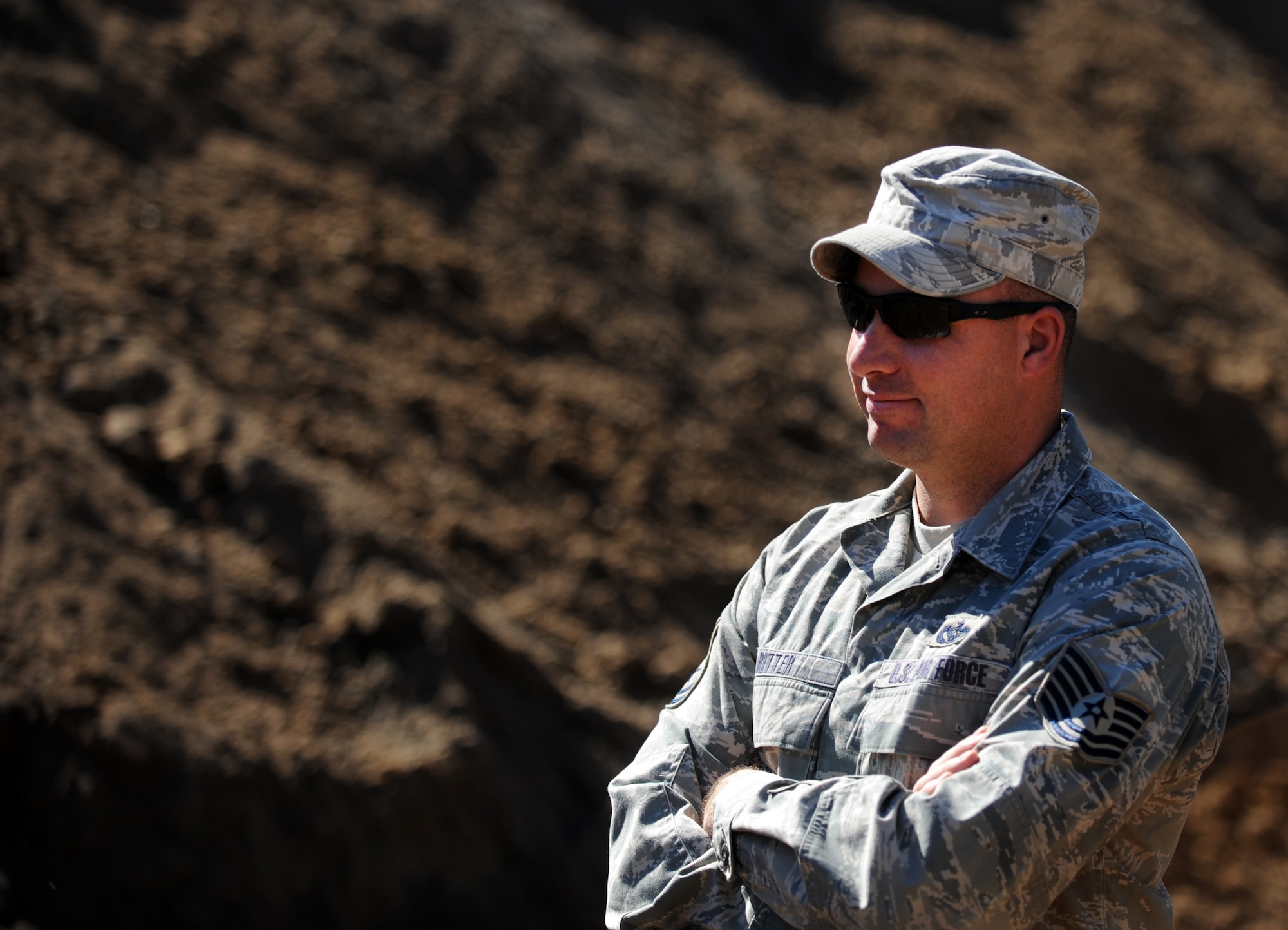 MOODY AIR FORCE BASE, Ga. -- Tech. Sgt. Joseph Ritter, 23rd Civil Engineer Squadron NCO in charge, watches as others from the 23rd CES build a berm at the Combat Arms Training and Maintenance range Feb. 14. About seven people were assigned to work on the project and Sergeant Ritter hopes to have it completed within three days. (U.S. Air Force photo/Airman 1st Class Douglas Ellis)(RELEASED)
