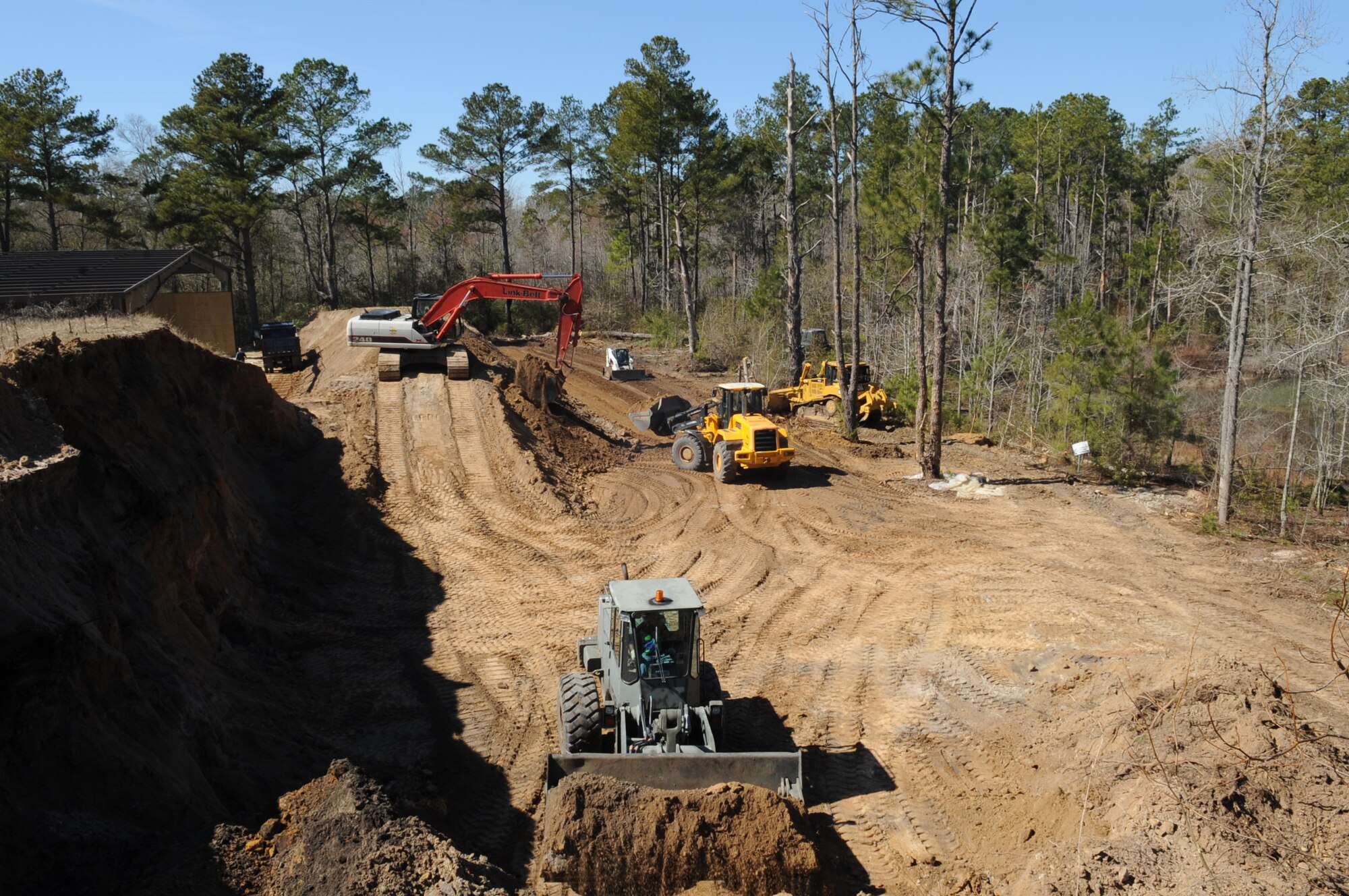 MOODY AIR FORCE BASE, Ga. -- Members of the 23rd Civil Engineer Squadron move dirt to create a berm at the Combat Arms Training and Maintenance range Feb. 14. The next step in building the berm is to add clean fill material to prevent bullets from ricocheting. (U.S. Air Force photo/Airman 1st Class Douglas Ellis)(RELEASED)
